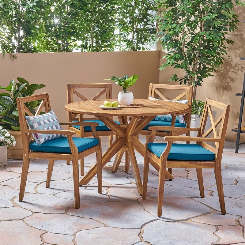 wood patio dining set with blue chair cushions
